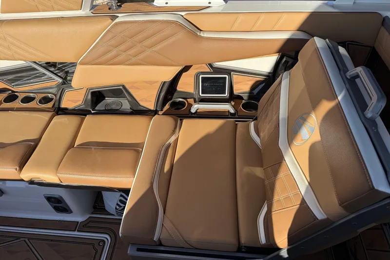 Slide: The Image of 2024 Tigé Ultré 23ZX boat interior with tan leather seats and cup holders. - 13