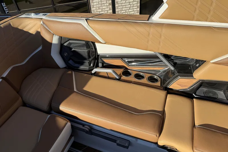 Slide: The Image of 2024 Tigé Ultré 23ZX boat interior with tan leather seats and cup holders. - 15