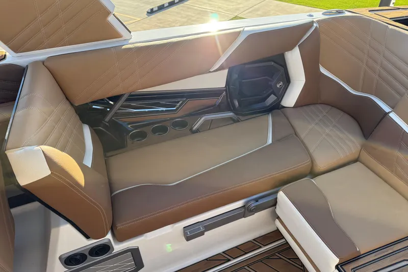 Slide: The Image of 2024 Tigé Ultré 23ZX boat interior with luxurious brown and white seating. - 16