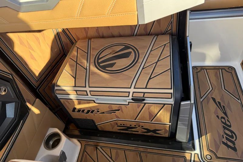 Slide: The Image of 2024 Tigé Ultré 23ZX interior with stylish wood paneling and logo detailing. - 17