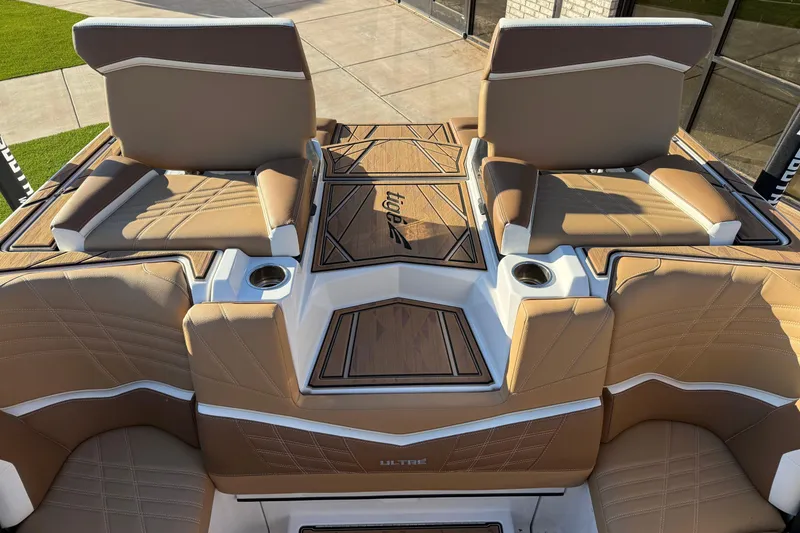 Slide: The Image of 2024 Tigé Ultré 23ZX boat interior with tan leather seats and cup holders. - 19