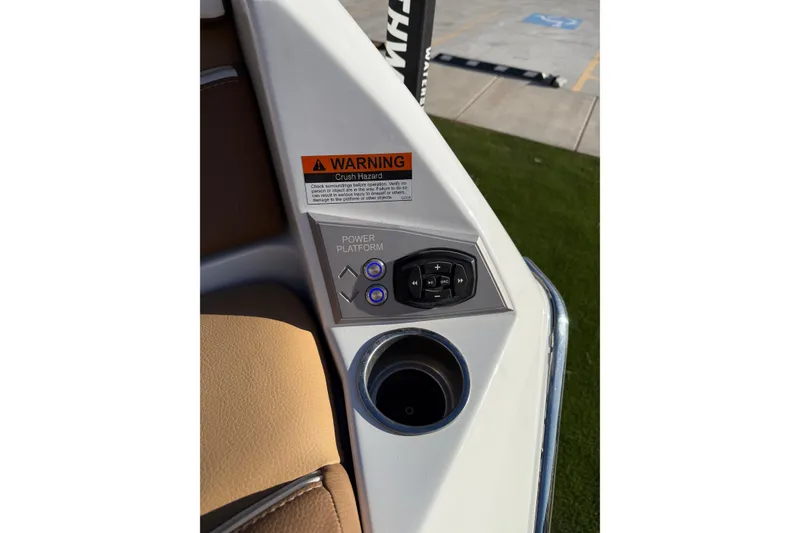 Slide: The Image of 2024 Tigé Ultré 23ZX boat control panel with warning label and cup holder. - 22