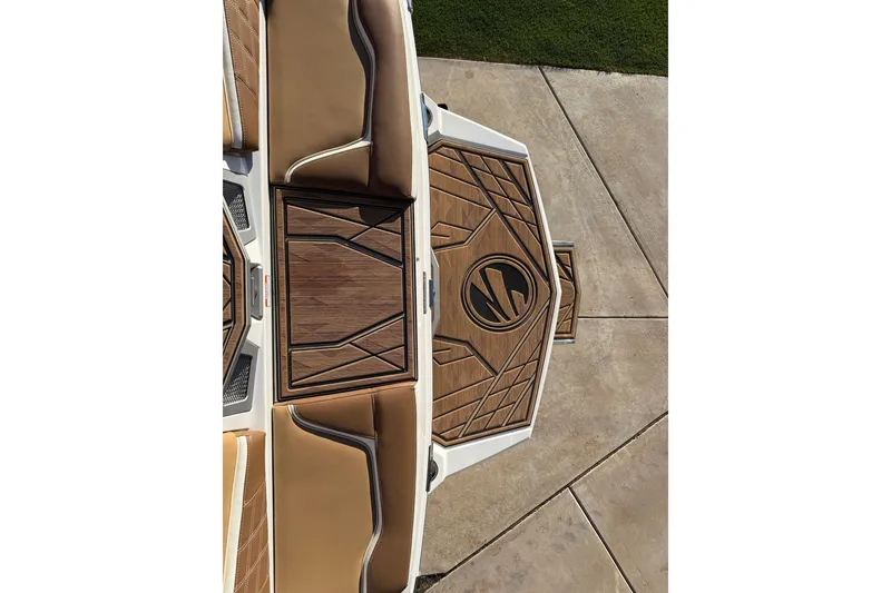 Slide: The Image of 2024 Tigé Ultré 23ZX boat interior with stylish brown seating and wood-patterned flooring. - 23