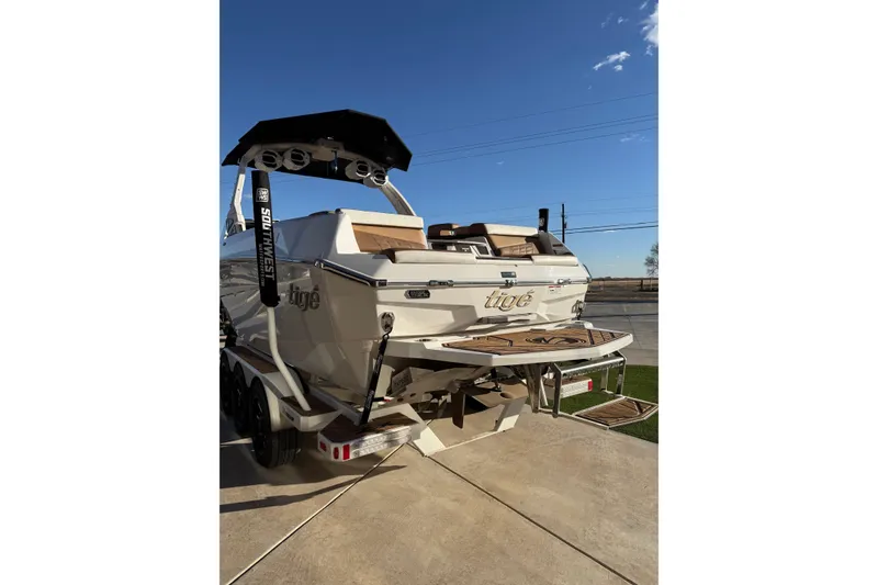 Slide: The Image of 2024 Tigé Ultré 23ZX boat on trailer, rear view, sunny day. - 26