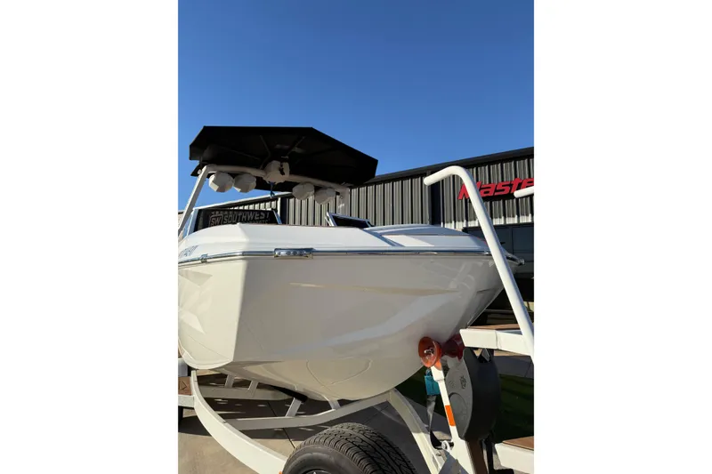 Slide: The Image of 2024 Tigé Ultré 23ZX boat on trailer under clear blue sky. - 5