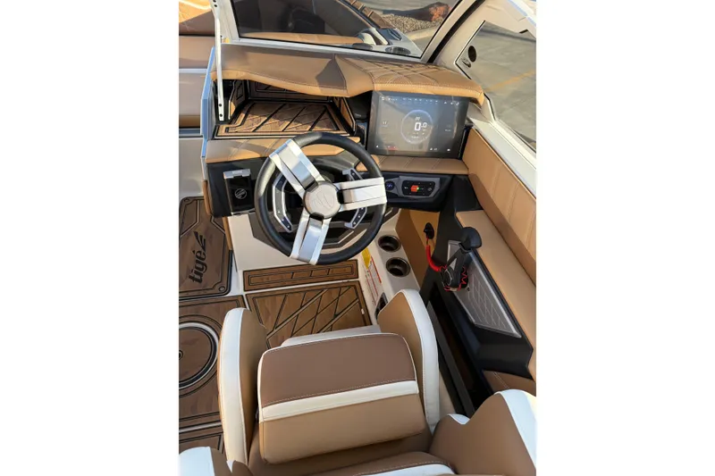 Slide: The Image of 2024 Tigé Ultré 23ZX boat interior with modern dashboard and steering wheel. - 9