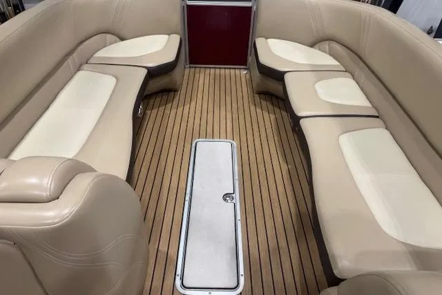 Slide: The Image of Interior of 2015 Harris Solstice 240 boat with beige seating and wooden flooring. - 10