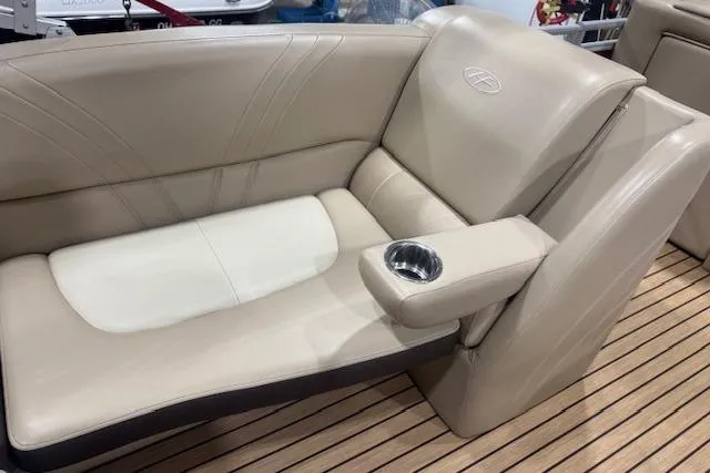 Slide: The Image of 2015 Harris Solstice 240 boat interior with beige leather seating and cup holder. - 12