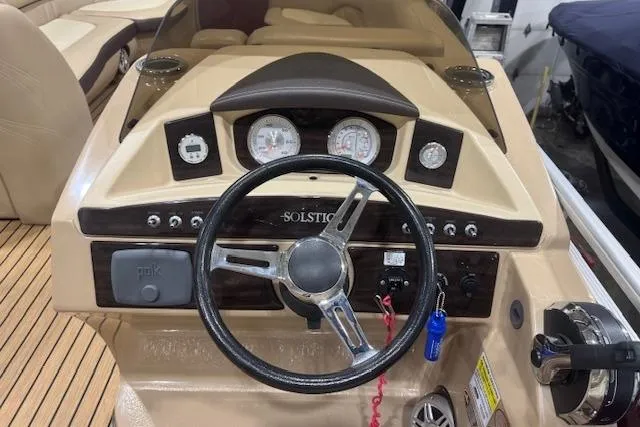 Slide: The Image of Steering console of a 2015 Harris Solstice 240 boat with gauges and controls. - 9