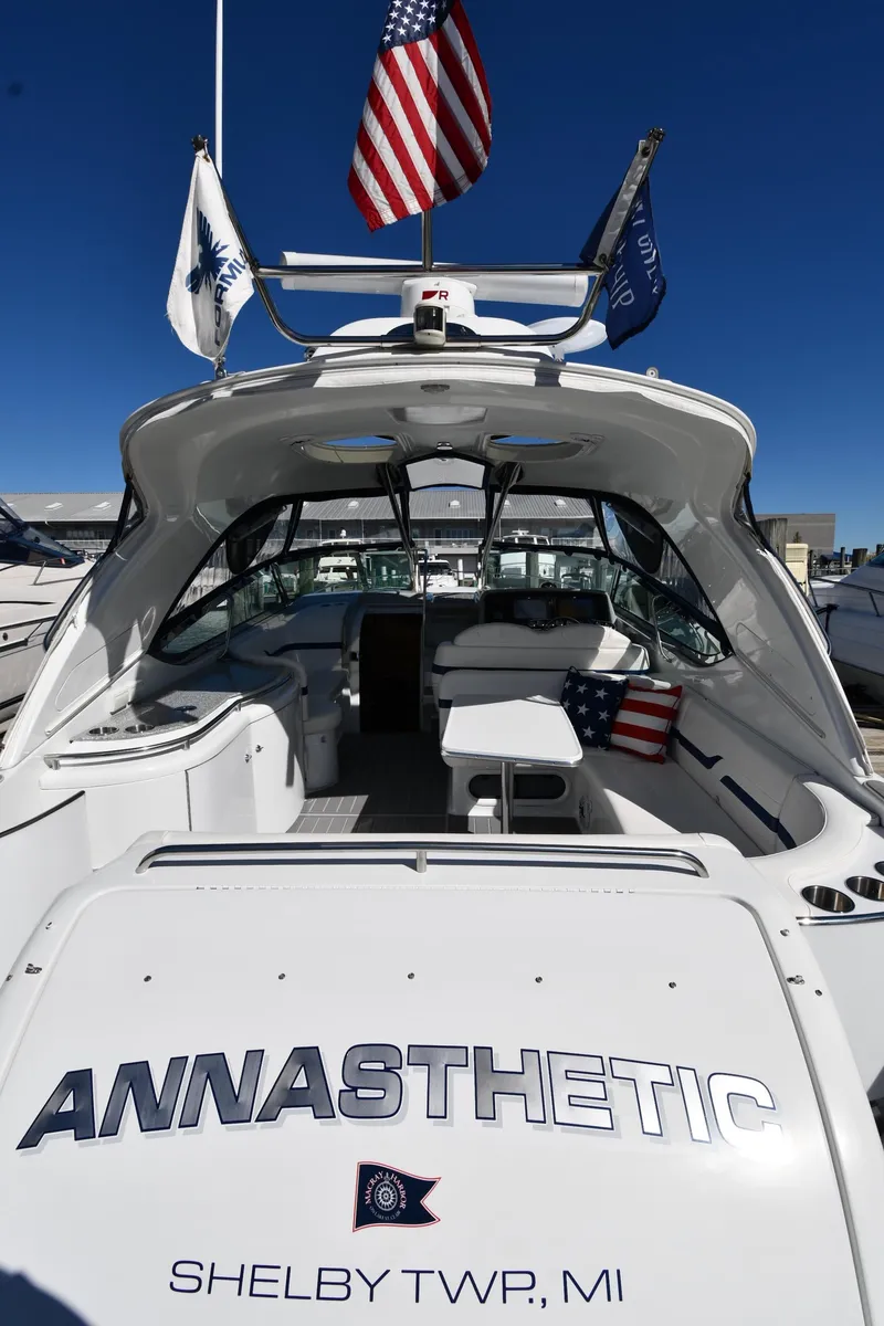 Slide: The Image of 2008 Formula 400 Super Sport boat with flags, docked. - 10