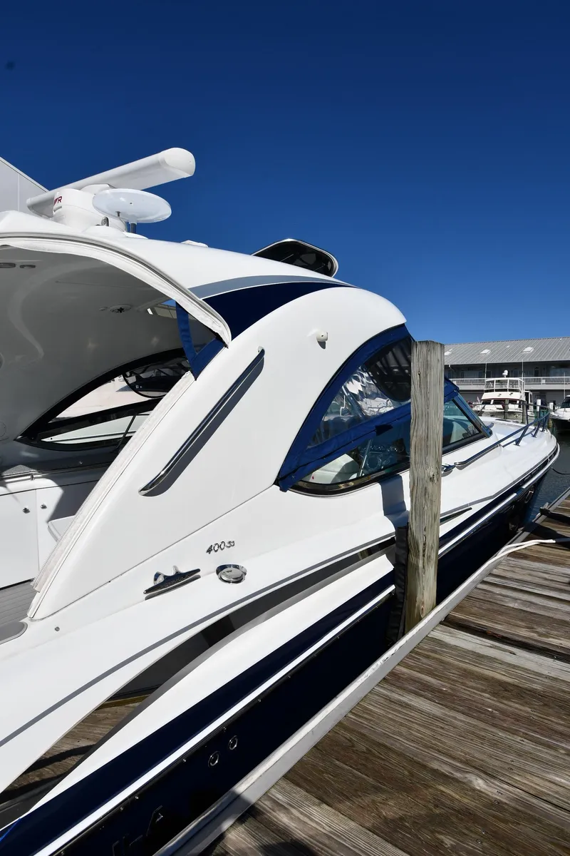Slide: The Image of 2008 Formula 400 Super Sport boat docked under clear sky. - 2