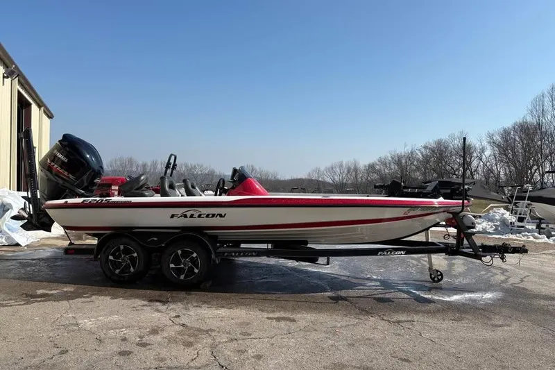 Slide: The Image of 2021 Falcon Boats F205 on trailer, parked outdoors under clear blue sky. - 1