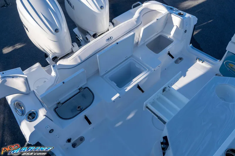 Slide: The Image of 2026 Sea Hunt Ultra 265 SE boat deck with storage compartments and dual engines. - 16