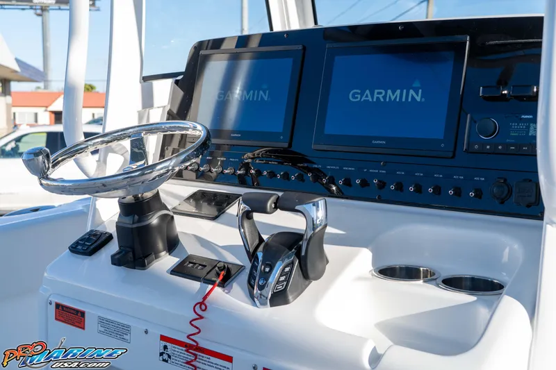 Slide: The Image of 2026 Sea Hunt Ultra 265 SE dashboard with Garmin displays and steering wheel. - 18