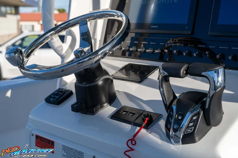 Slide: The Image of Steering console of 2026 Sea Hunt Ultra 265 SE boat with modern controls. - 19