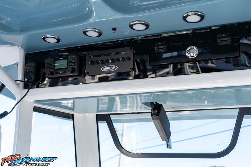 Slide: The Image of 2026 Sea Hunt Ultra 265 SE boat console with electronic controls and overhead lighting. - 22