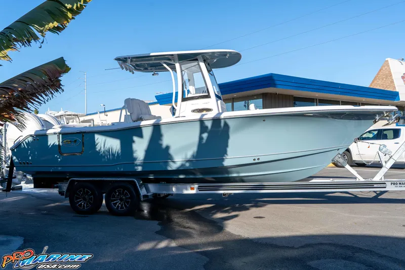 Slide: The Image of 2026 Sea Hunt Ultra 265 SE boat on trailer, displayed outdoors. - 7