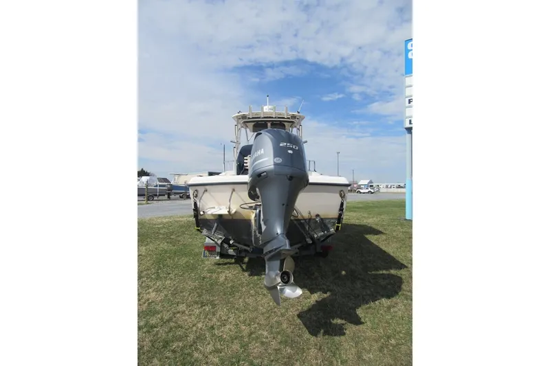 Slide: The Image of 2004 Grady-White Seafarer 228 boat with Yamaha 250 outboard motor, parked on grass. - 13