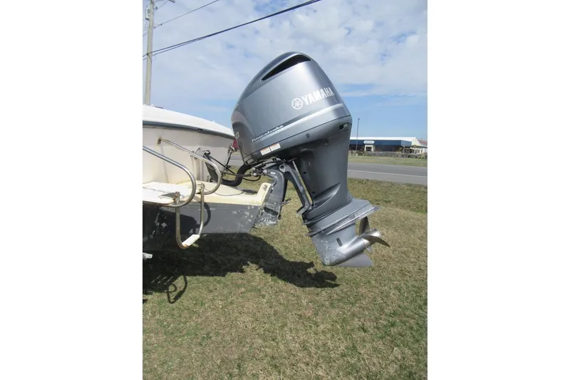Slide: The Image of Outboard motor on 2004 Grady-White Seafarer 228 boat, parked on grass. - 14