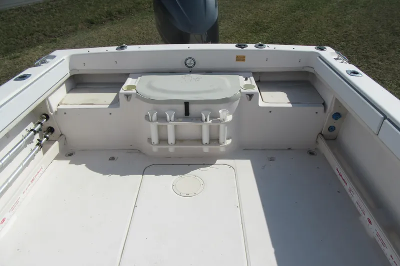 Slide: The Image of 2004 Grady-White Seafarer 228 boat deck with rod holders and storage compartments. - 15