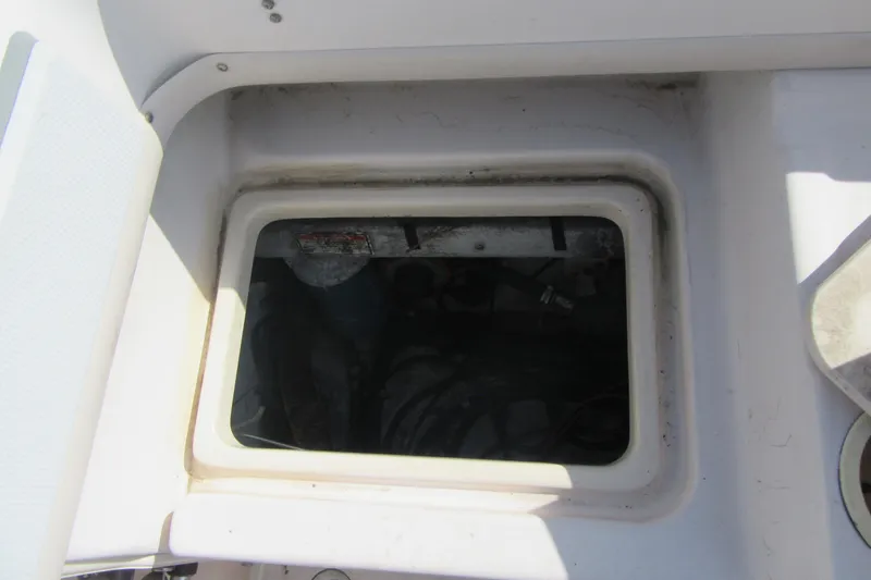 Slide: The Image of Hatch opening on a 2004 Grady-White Seafarer 228 boat, showing interior compartment. - 17