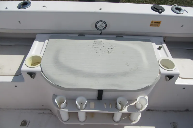 Slide: The Image of 2004 Grady-White Seafarer 228 boat deck with rod holders and storage compartment. - 18