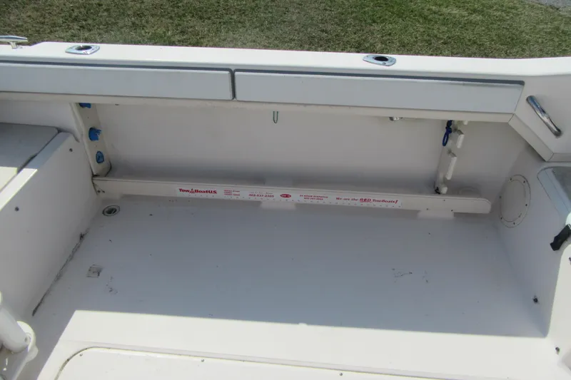 Slide: The Image of 2004 Grady-White Seafarer 228 boat interior, featuring clean white deck and storage area. - 19