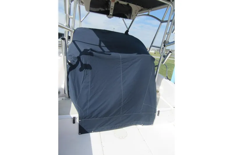 Slide: The Image of 2004 Grady-White Seafarer 228 boat with covered console, outdoor setting. - 21