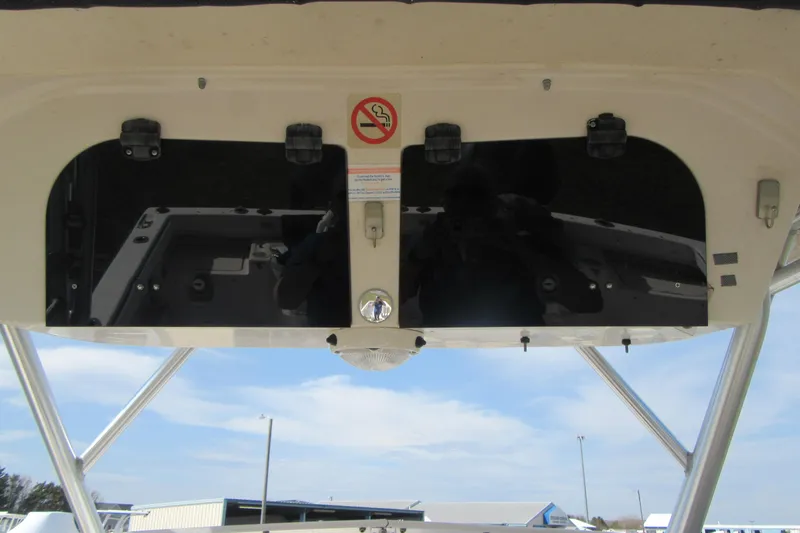 Slide: The Image of 2004 Grady-White Seafarer 228 boat console with no smoking sign, under clear blue sky. - 35