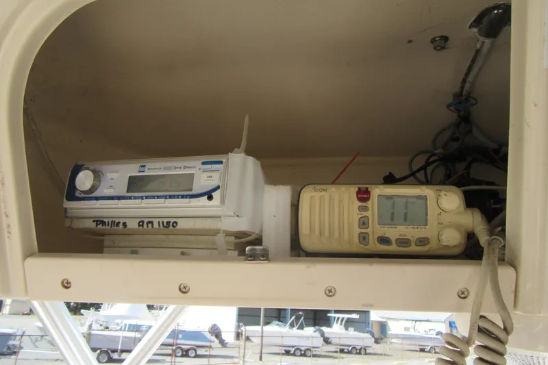 Slide: The Image of 2004 Grady-White Seafarer 228 boat electronics, featuring radio and communication devices. - 36