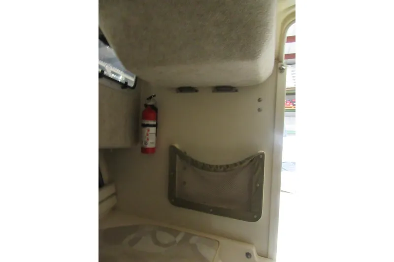 Slide: The Image of Interior of 2004 Grady-White Seafarer 228 with fire extinguisher and storage net. - 43