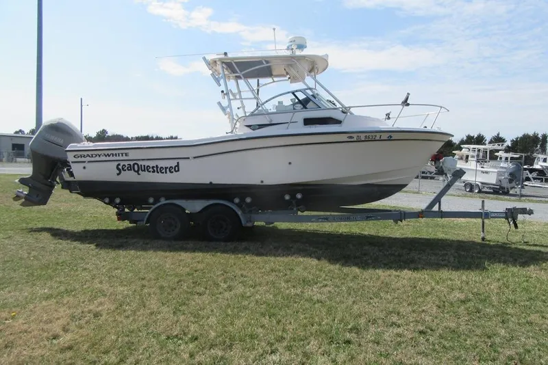 Slide: The Image of 2004 Grady-White Seafarer 228 boat on trailer, parked on grass. - 9