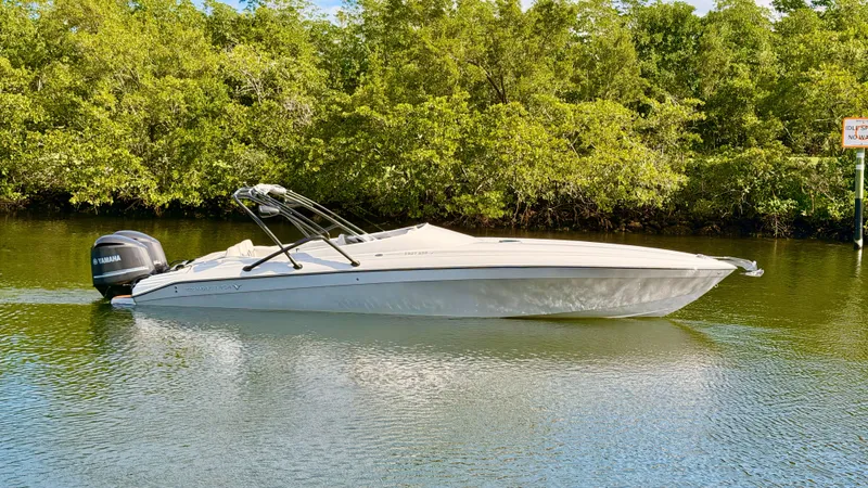 The Image of Pronautica 33 Sport 2014 on calm water with green backdrop. - 0