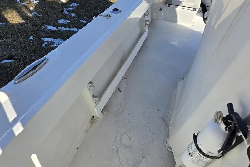 Slide: The Image of 2021 Parker 2100 CC boat interior with white deck and fire extinguisher. - 11