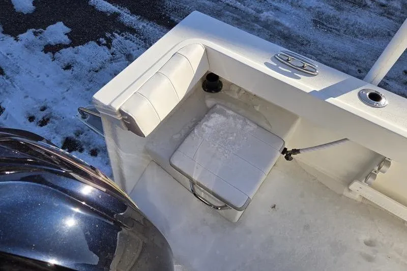 Slide: The Image of 2021 Parker 2100 CC boat interior with snowy seat and motor. - 12