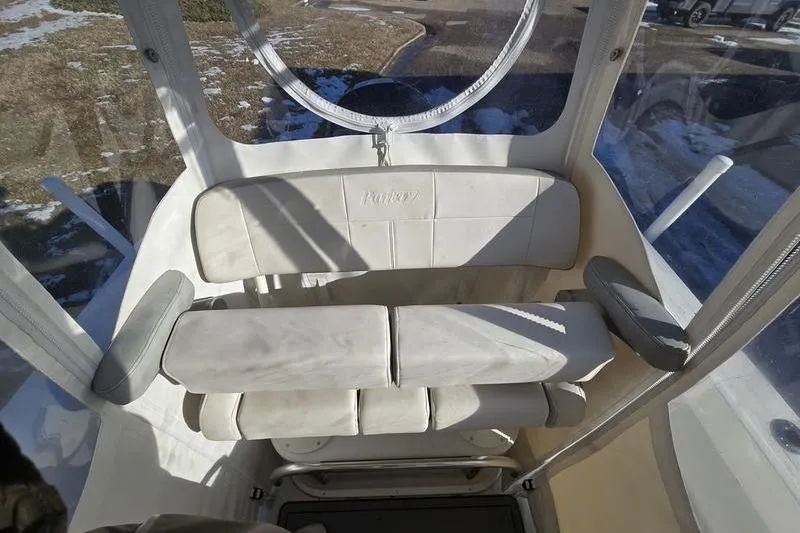 Slide: The Image of 2021 Parker 2100 CC boat interior with cushioned seating and clear enclosure. - 4