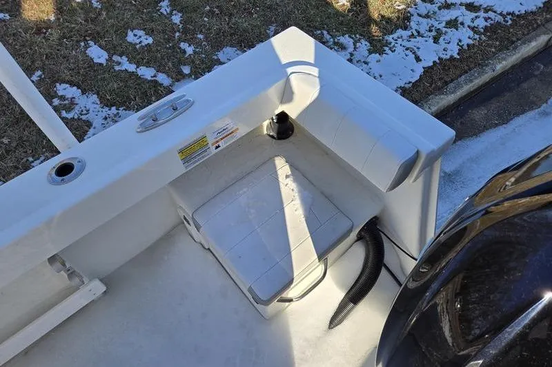 Slide: The Image of 2021 Parker 2100 CC boat interior with seating and snow-covered ground. - 9