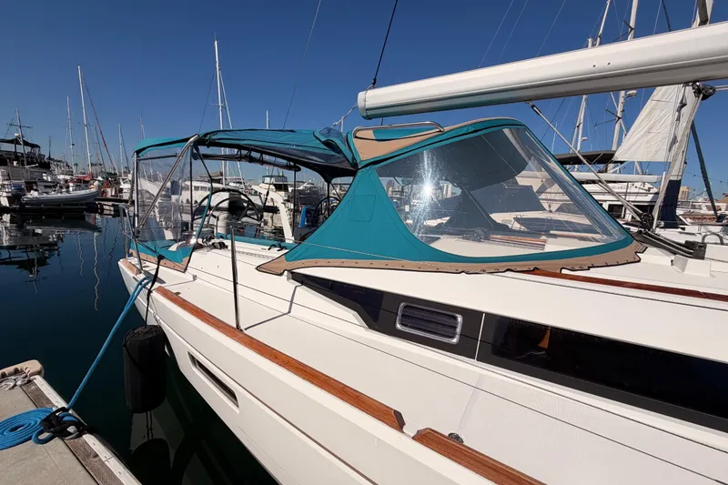 Slide: The Image of 2014 Jeanneau Sun Odyssey 469 sailboat docked at marina with blue canopy. - 12