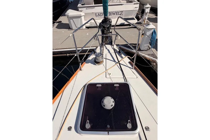 Slide: The Image of 2014 Jeanneau Sun Odyssey 469 sailboat deck with hatch and railing at marina. - 16