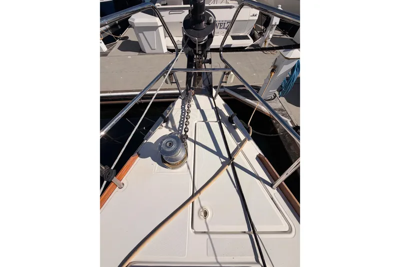 Slide: The Image of 2014 Jeanneau Sun Odyssey 469 yacht deck with winch and railing at marina. - 19