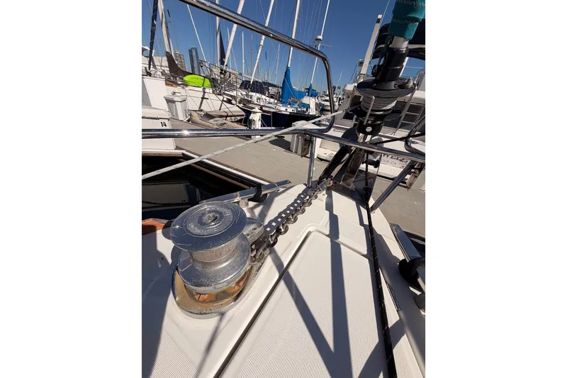 Slide: The Image of 2014 Jeanneau Sun Odyssey 469 sailboat deck with anchor chain and winch. - 21