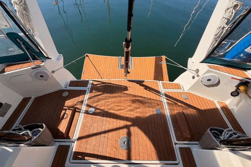Slide: The Image of Cockpit of 2014 Jeanneau Sun Odyssey 469 with teak flooring and water view. - 30