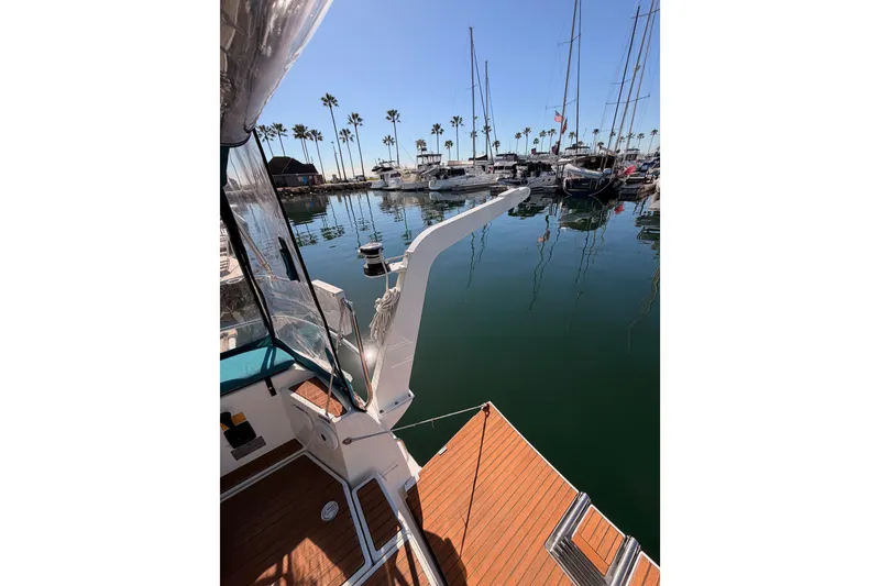 Slide: The Image of 2014 Jeanneau Sun Odyssey 469 docked in a marina with clear blue skies. - 32