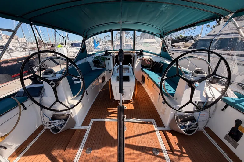Slide: The Image of Cockpit of 2014 Jeanneau Sun Odyssey 469 sailboat with dual steering wheels and teak flooring. - 34