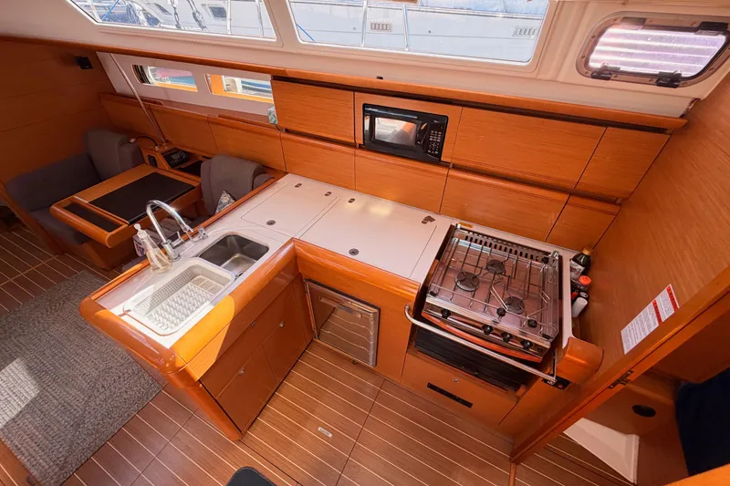 Slide: The Image of 2014 Jeanneau Sun Odyssey 469 yacht interior with modern kitchen and dining area. - 48