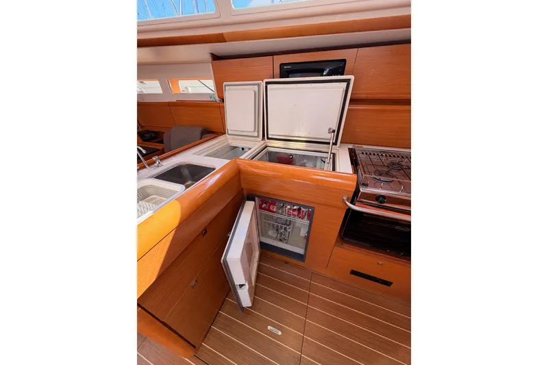 Slide: The Image of Interior of 2014 Jeanneau Sun Odyssey 469 yacht kitchen with appliances and wooden cabinetry. - 51
