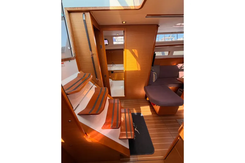 Slide: The Image of Interior of 2014 Jeanneau Sun Odyssey 469 sailboat with wooden flooring and seating area. - 58