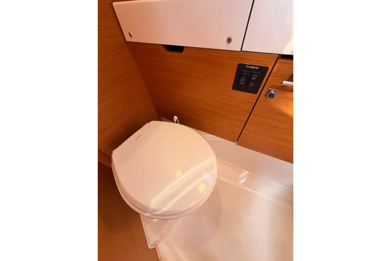 Slide: The Image of 2014 Jeanneau Sun Odyssey 469 yacht bathroom with modern toilet and wooden cabinetry. - 61