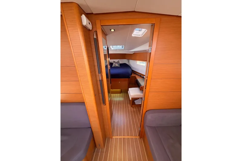 Slide: The Image of Interior of 2014 Jeanneau Sun Odyssey 469 sailboat, featuring cozy cabin and wooden finishes. - 79