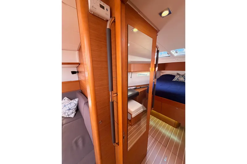 Slide: The Image of Interior of 2014 Jeanneau Sun Odyssey 469 yacht, featuring cozy cabin and wooden finishes. - 81